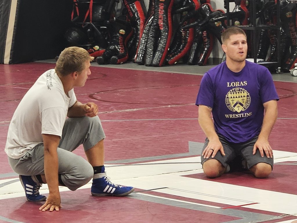 Loras wrestling coach Devin Bahr talks to campers during a clinic at Holmen High School. -- TODD SOMMERFELDT PHOTO