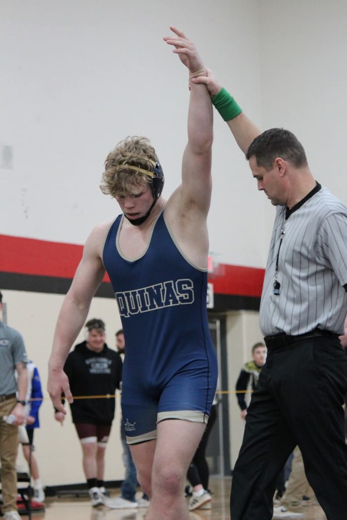 Tyson Martin has his hand raised after winning another wrestling match. -- AMY HARGROVE PHOTO