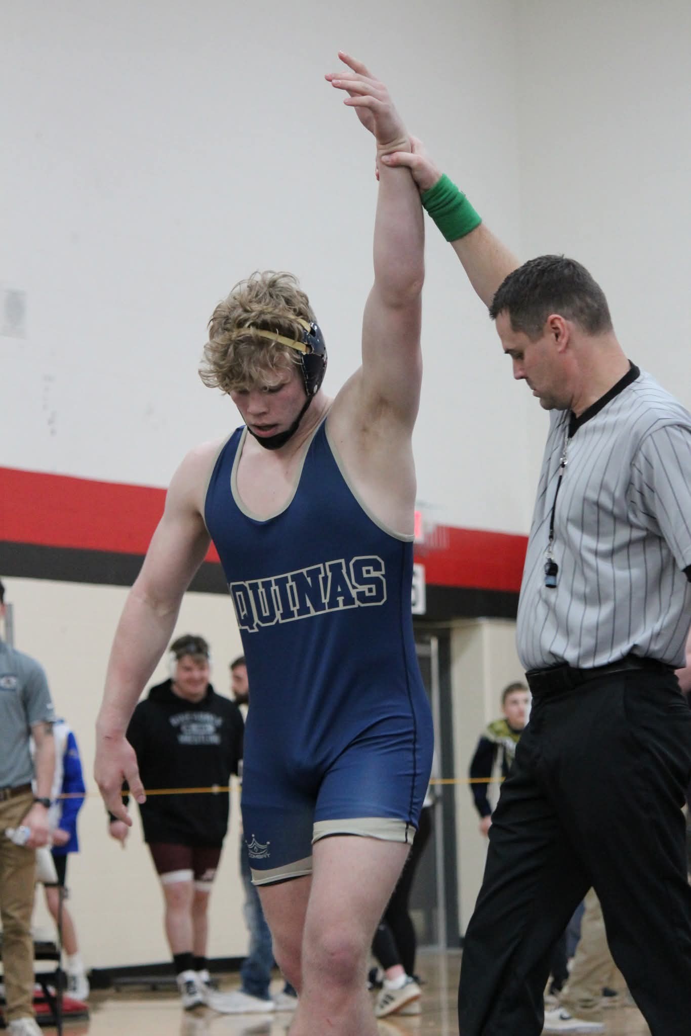 Tyson Martin has his hand raised after winning another wrestling match. -- AMY HARGROVE PHOTO