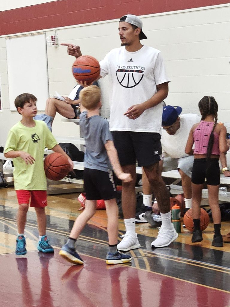 Johnny Davis, a lottery pick by the Washington Wizards in 2022, oversees campers during a training session at Central High School. -- TODD SOMMERFELDT PHOTO