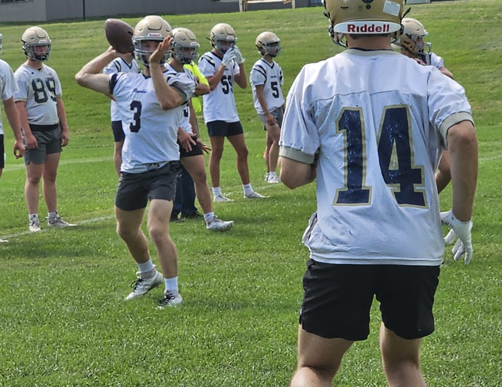 Aquinas quarterback Isaac Miller throws a pass during Tuesday's first football practice of the season. -- TODD SOMMERFELDT PHOTO