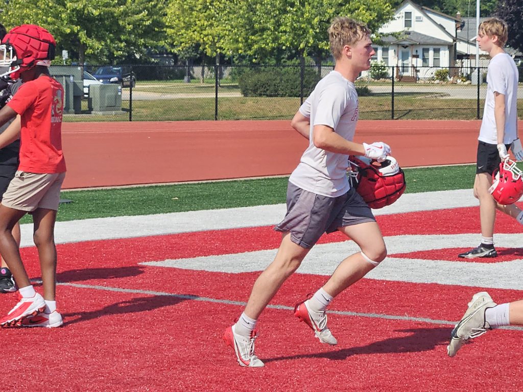 Logan senior Jackson Bosch runs back to the practice field after a quick water break on Tuesday. -- TODD SOMMERFELDT PHOTO