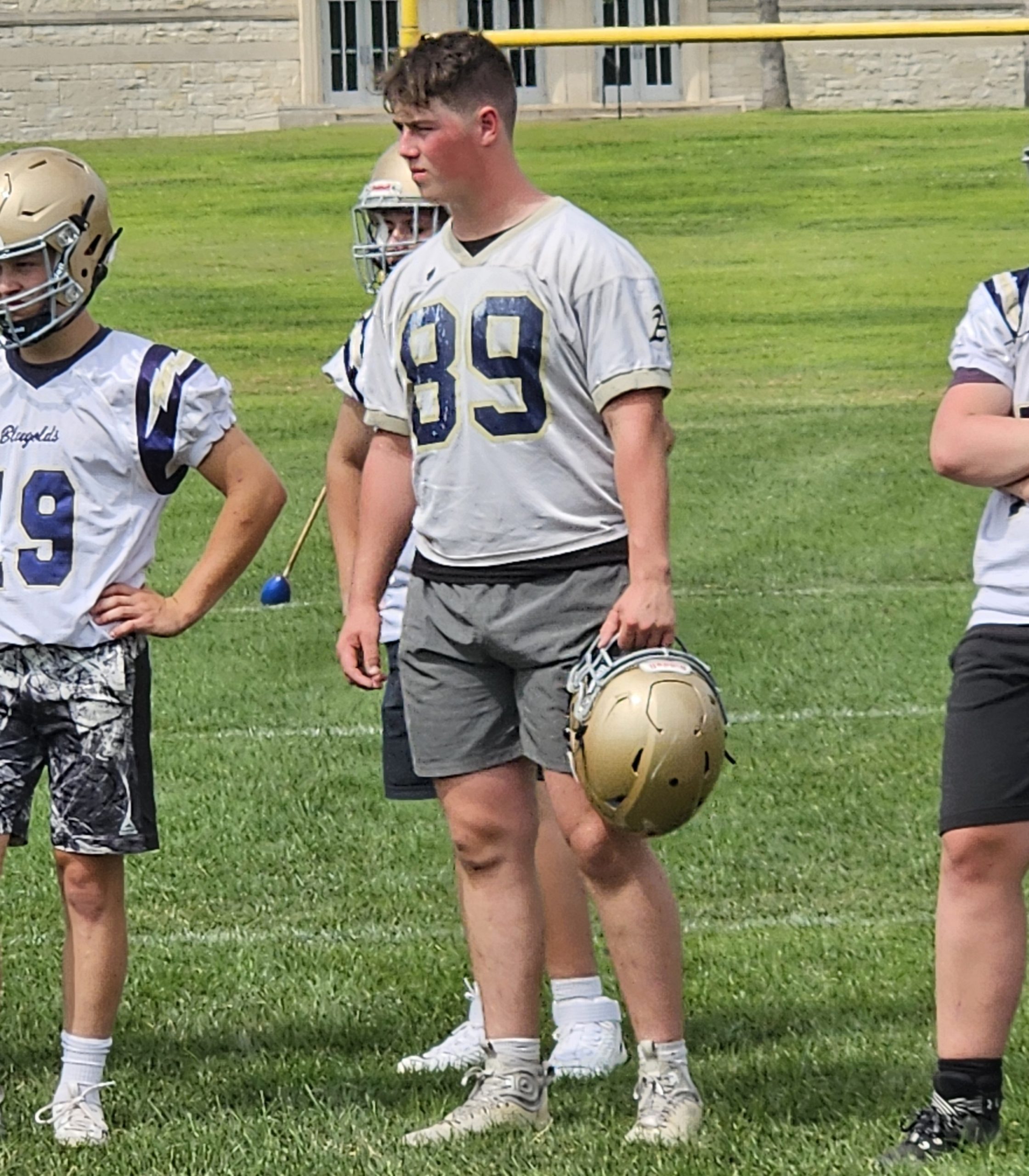 Aquinas senior Will Flottmeyer listens to instruction at Tuesday's first football practice of the season. -- TODD SOMMERFELDT PHOTO