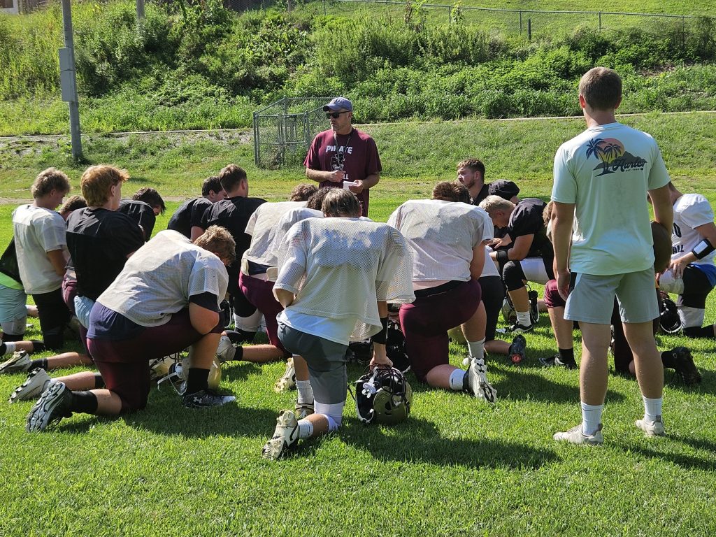Coach Ev Wick talks to the De Soto football team before a practice. -- TODD SOMMERFELDT PHOTO