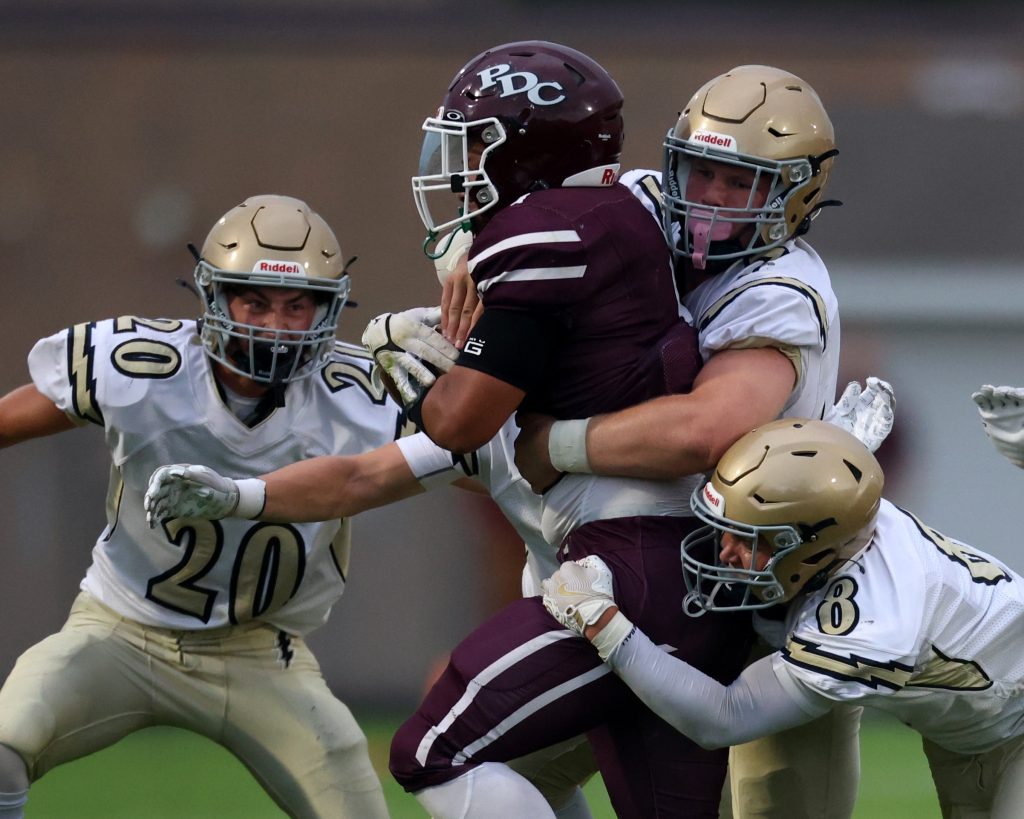 The Aquinas football team's defense makes a tackle during Friday's game at Prairie du Chien. -- NATE BEIER PHOTO