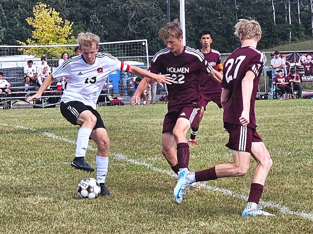 Central junior Alex Heiderscheit battles the defense of Holmen's Preston McHugh in an MVC soccer game. -- TODD SOMMERFELDT PHOTO