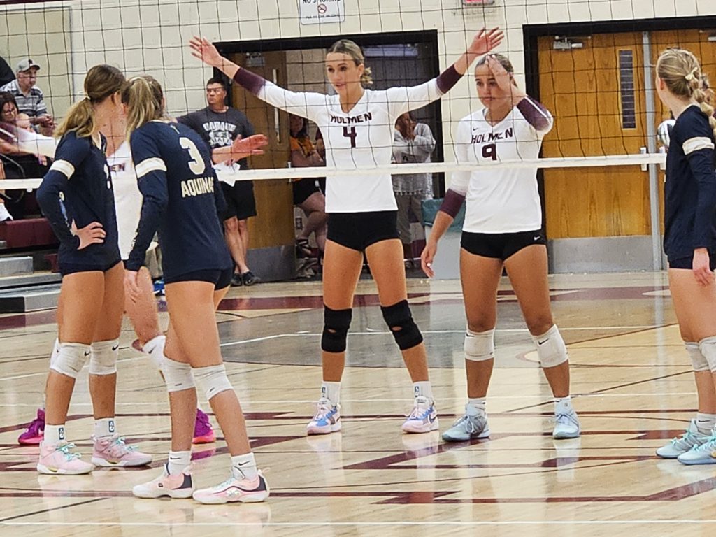 Holmen's Charley Casey and Moira Linse await an Aquinas serve at the Bernie L. Ferry Fieldhouse. -- TODD SOMMERFELDT PHOTO
