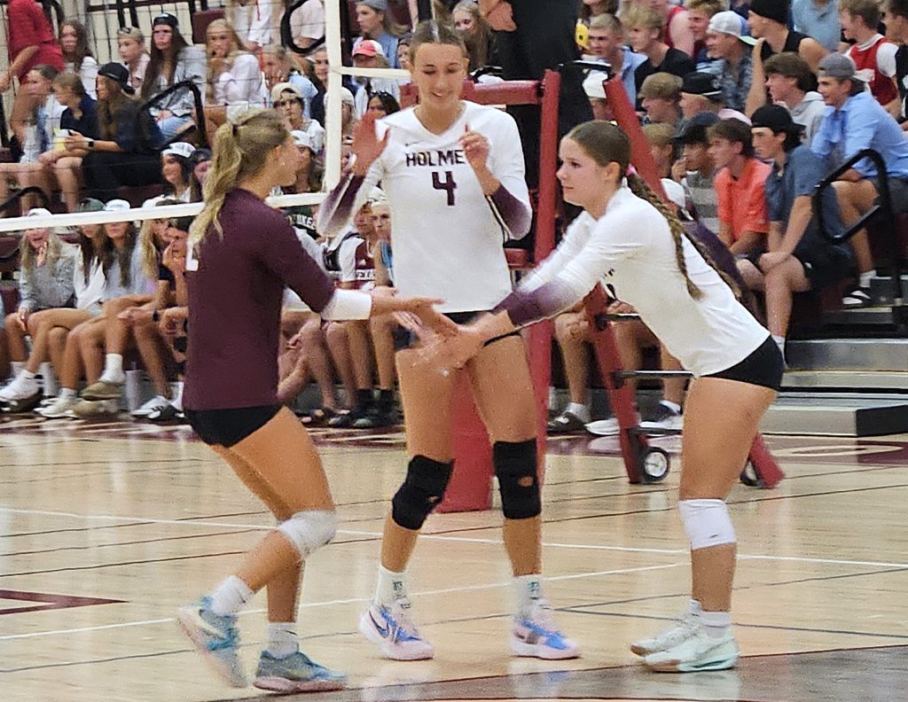 Holmen seniors Macy Kline, Charley Casey and Makenna McHugh celebrate a point during Tuesday's win over Aquinas at the Bernie L. Ferry Fieldhouse. -- TODD SOMMERFELDT PHOTO