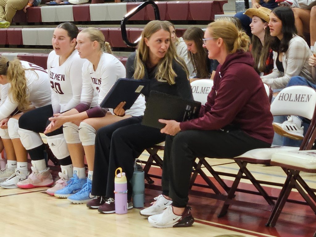 Holmen coaches Nicky Rose (right) and Sammi Maier talk during the Vikings' MVC match against Aquinas at the Bernie L. Ferry Fieldhouse. -- TODD SOMMERFELDT PHOTO