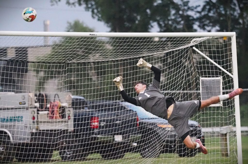 Aquinas junior, Cameron Reinhart blocks a shot at the goal during the Aquinas vs. Logan boys soccer game held at Fields for Kids Tuesday night. -- TARA WALTERS PHOTO