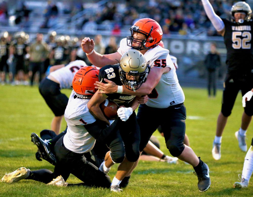 Caledonia running back Jack Schmitz powers through a couple of St. Charles defenders during Friday's 40-16 victory. -- CRAIG JOHNSON PHOTO