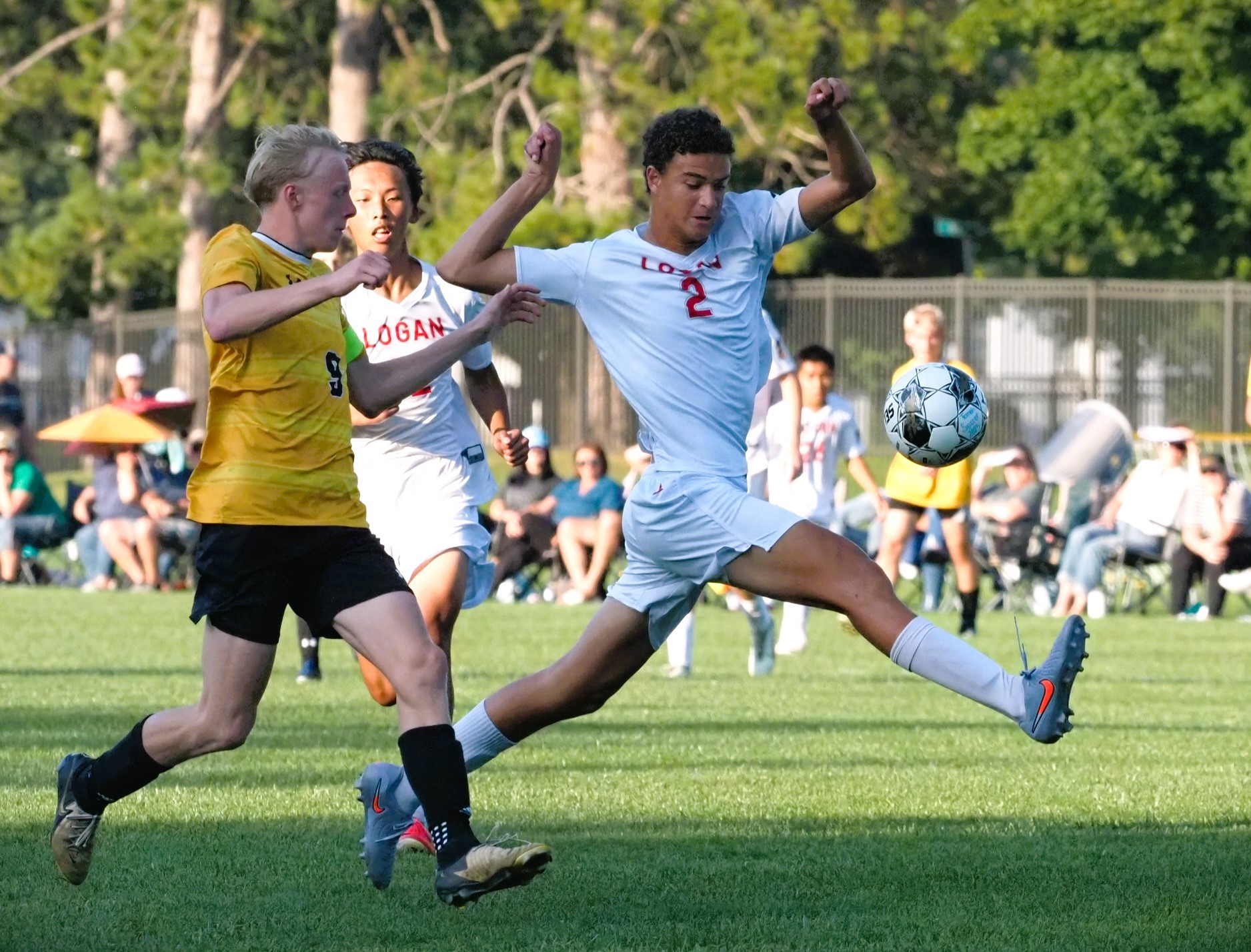 Logan's Mitchell Jarrett kicks the ball to take control from Tomah's Jaxon Ruland with the help of his teammate Andy Vue.. -- TARA WALTERS PHOTO