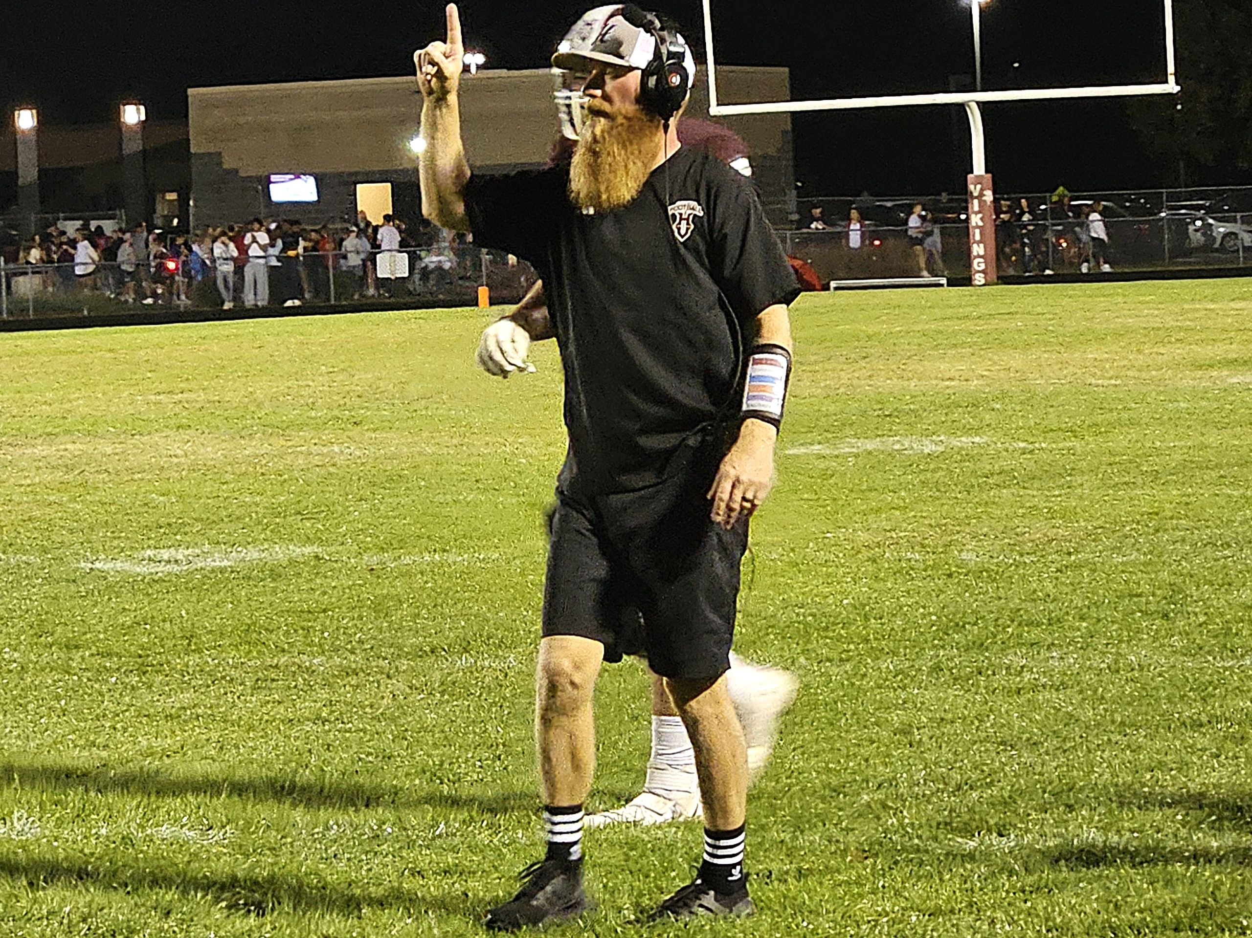 Holmen football coach Travis Kowalski signals for an extra-point kick after one of Holmen's six touchdowns against Sparta on Friday. -- TODD SOMMERFELDT PHOTO