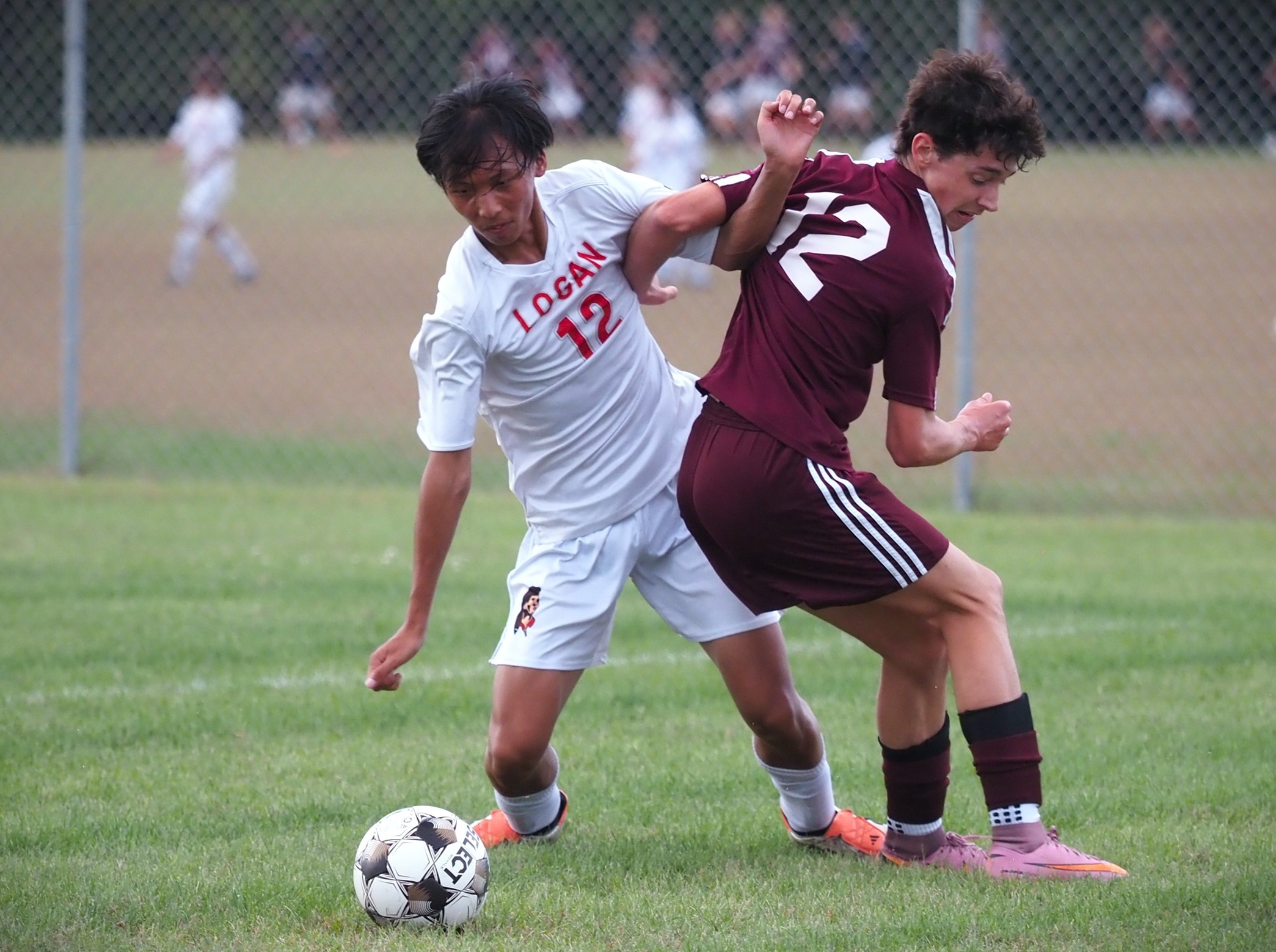 Logan's Andy Vue battles with Holmen's Teagan Rand for the soccer ball during a game in Holmen on Thursday. -- TARA WALTERS PHOTO
