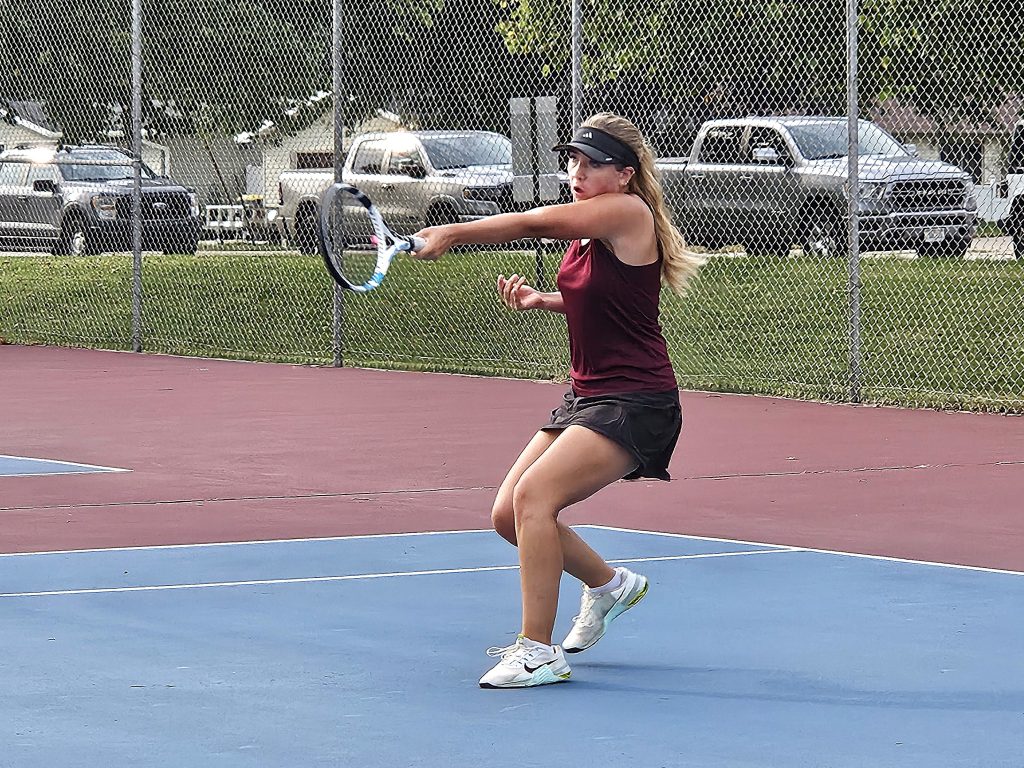 Holmen's Parc Tande follows through on a return during her No 1 singles match against Onalaska on Thursday. -- TODD SOMMERFELDT PHOTO