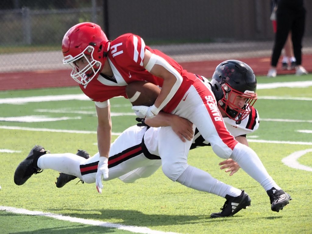 Logan's Andrew Stanton tries to break a tackle during Saturday's football game against Central at Swanson Field. -- TARA WALTERS PHOTO
