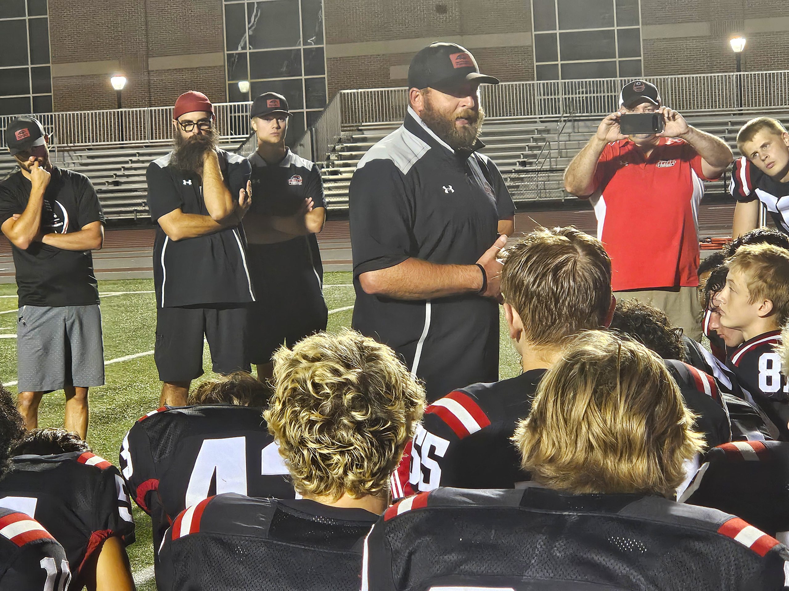 Central football coach Mitch Olson talks to his team after a 54-33 victory over Sparta. -- TODD SOMMERFELDT PHOTO