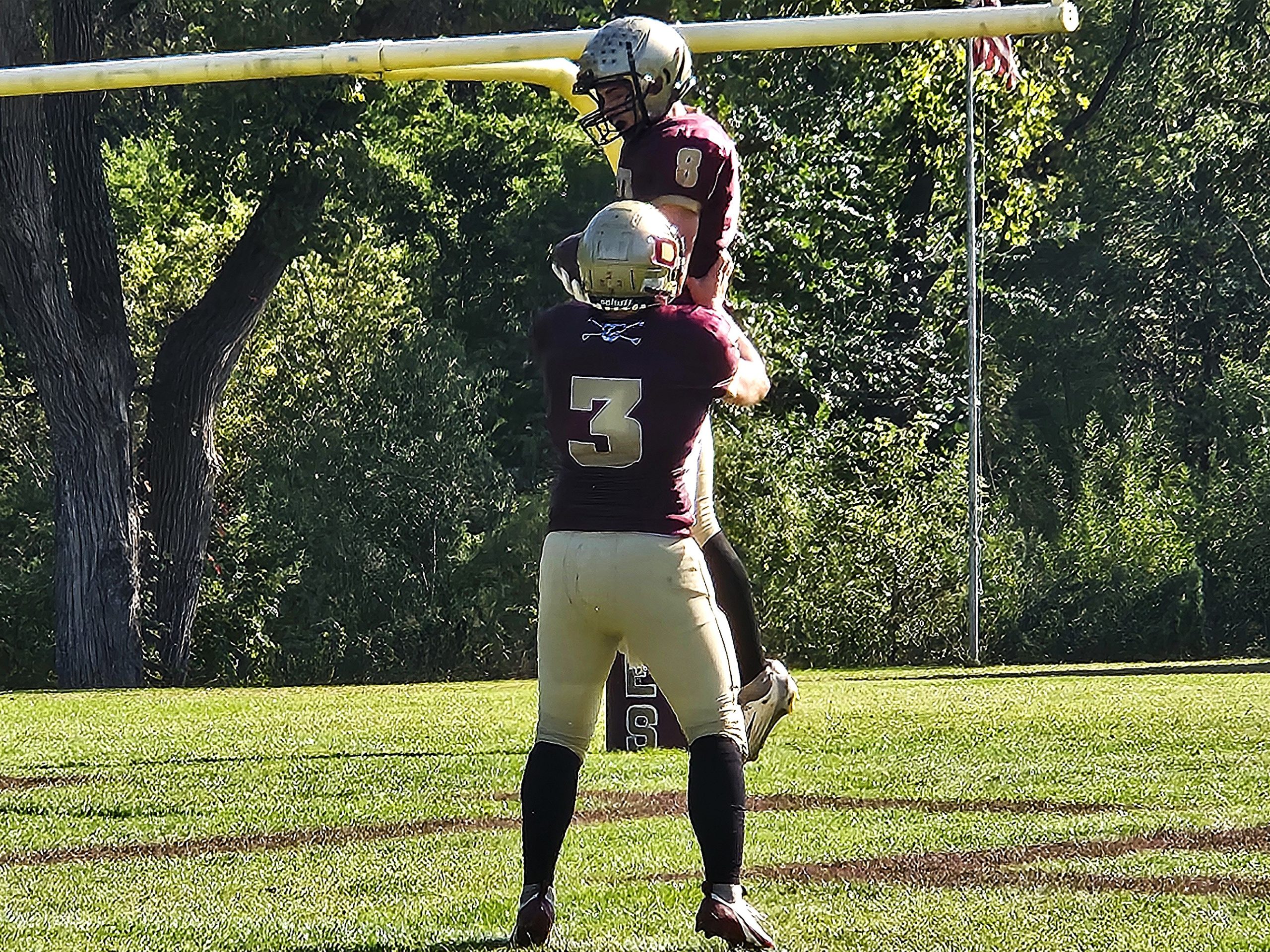 De Soto senior Jackson Trussoni (8) is congratulated by quarterback Finn Wrobel after one of his three touchdown catches against Monticello on Friday. -- TODD SOMMERFELDT PHOTO