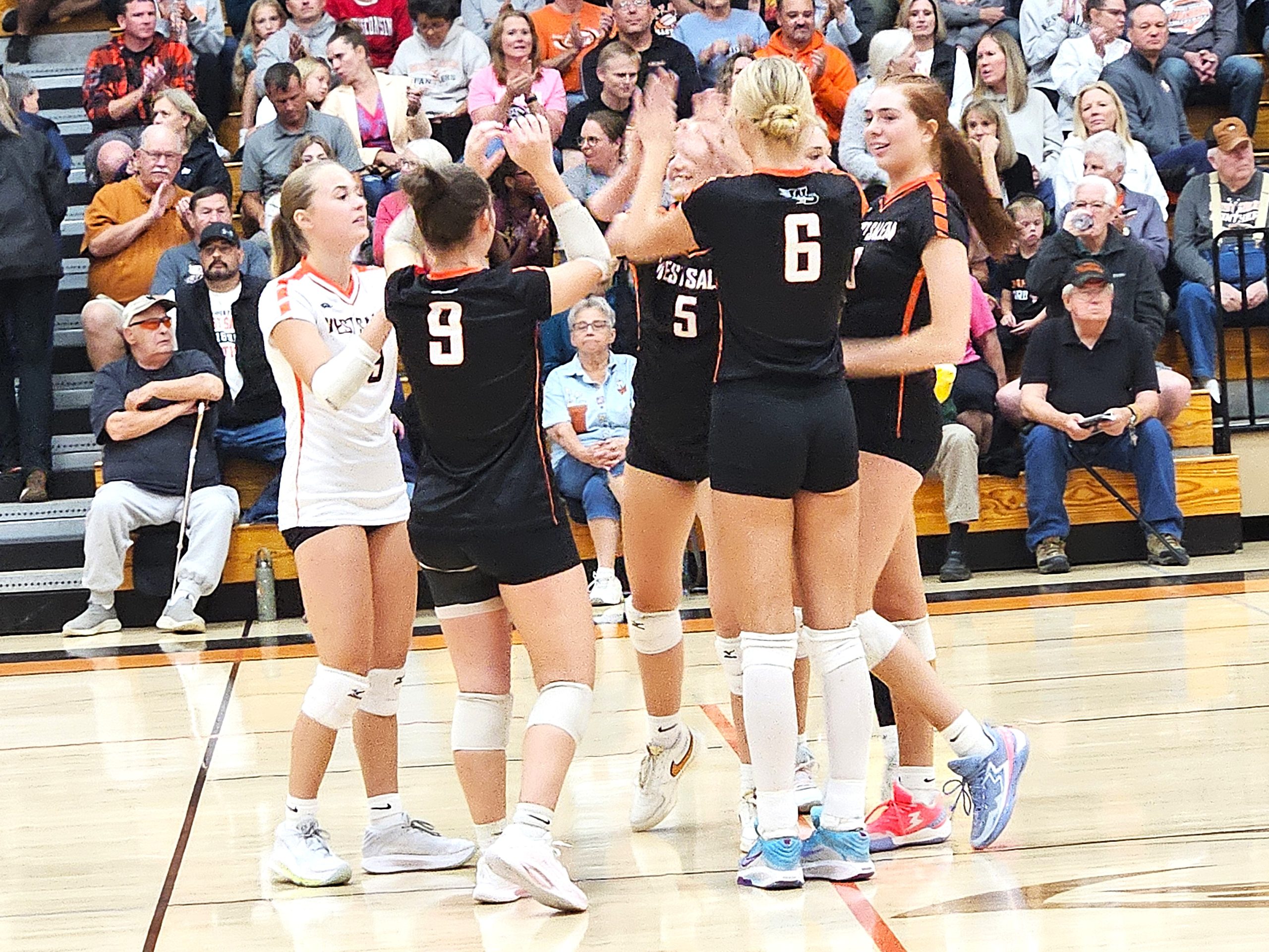 The West Salem volleyball team celebrates a point during a Coulee Conference match against Viroqua. -- PHOTO BY TODD SOMMERFELDT