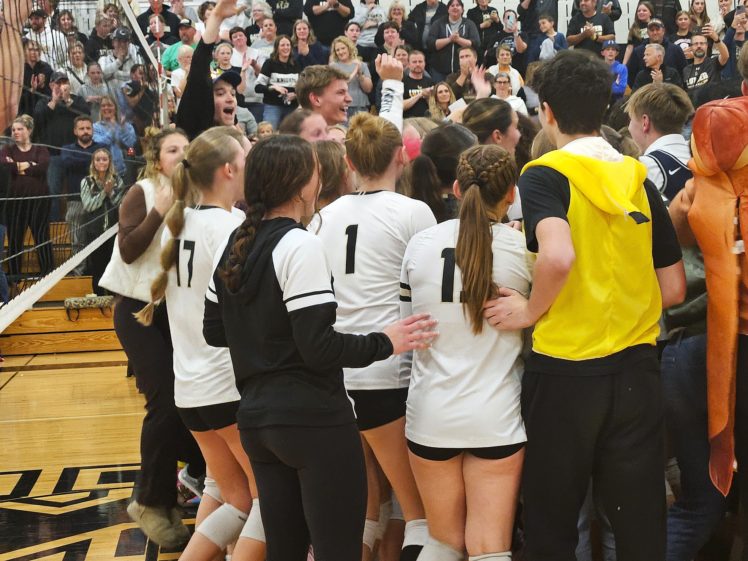 Members of the Onalaska Luther volleyball team celebrate with students after beating Aquinas in a WIAA Division 3 sectional semifinal on Thursday. -- TODD SOMMERFELDT PHOTO