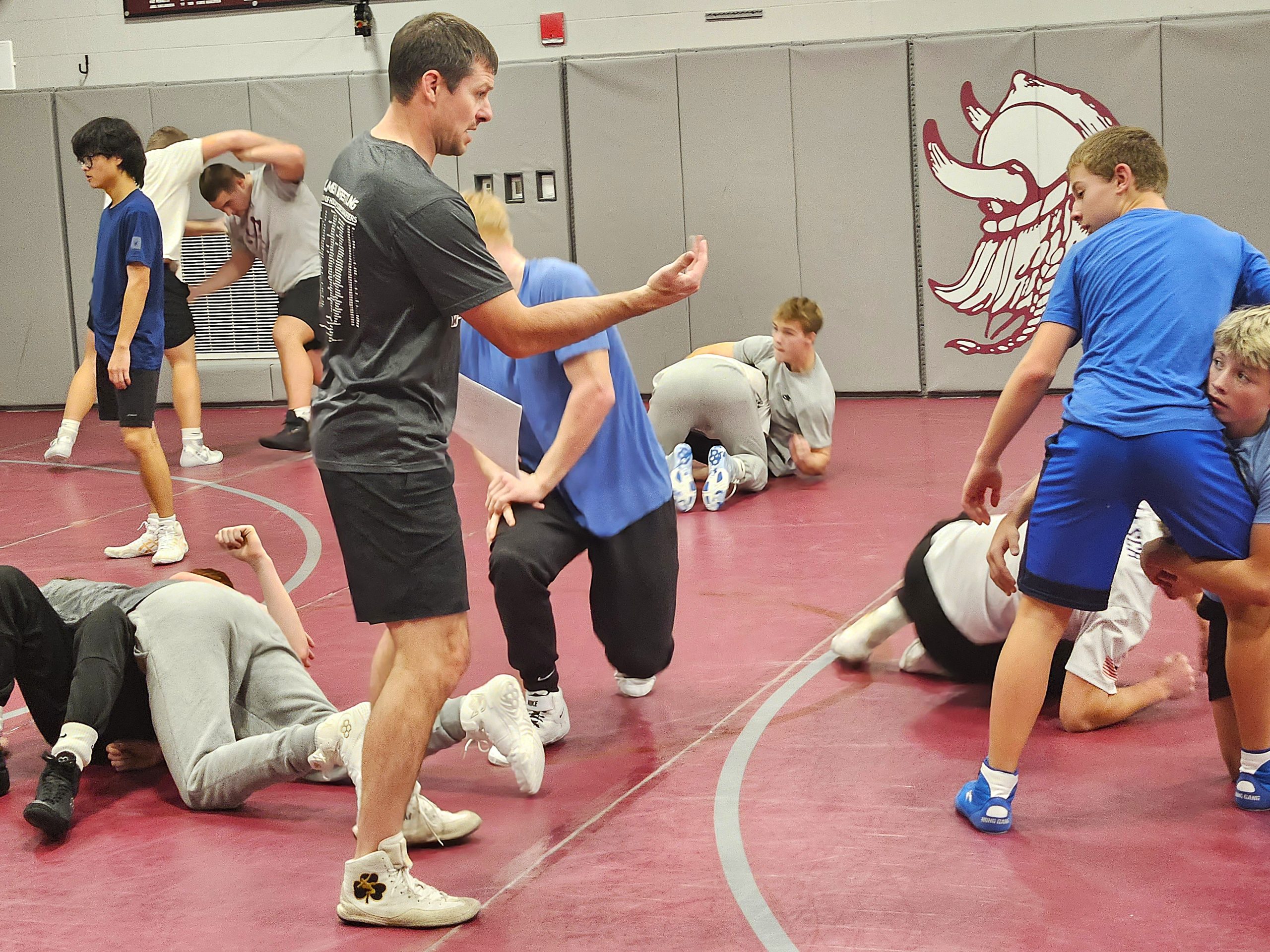 Holmen boys wrestling coach Justin Lancaster works with his team during practice. -- TODD SOMMERFELDT PHOTO