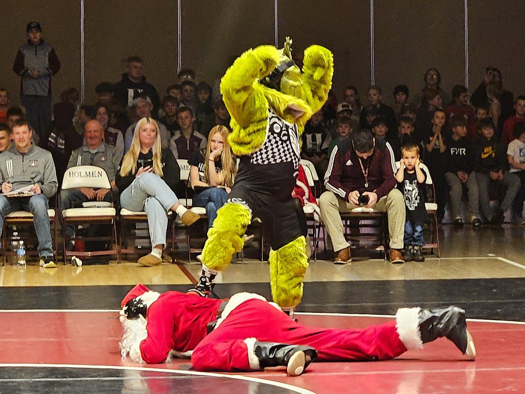 The Grinch has a temporary upper hand during his match against Santa Claus in Holmen on Thursday. -- TODD SOMMERFELDT PHOTO