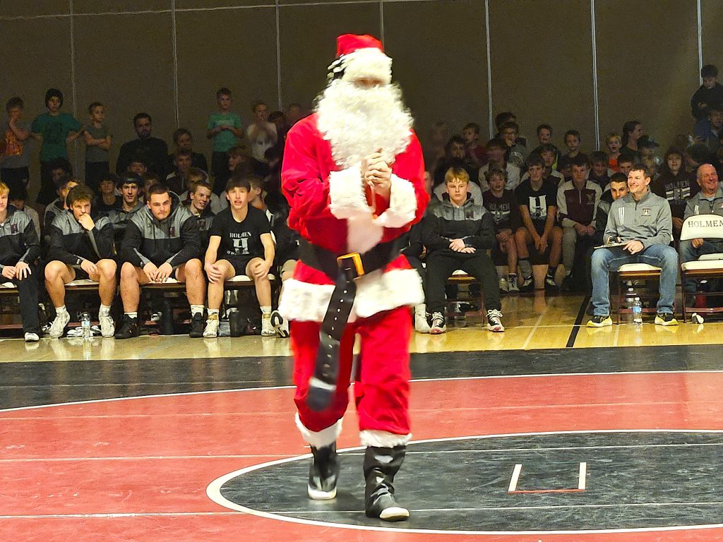 Santa Claus takes the mat for his match against the Grinch in Holmen on Thursday. Santa Claus won by pin. -- TODD SOMMERFELDT PHOTO
