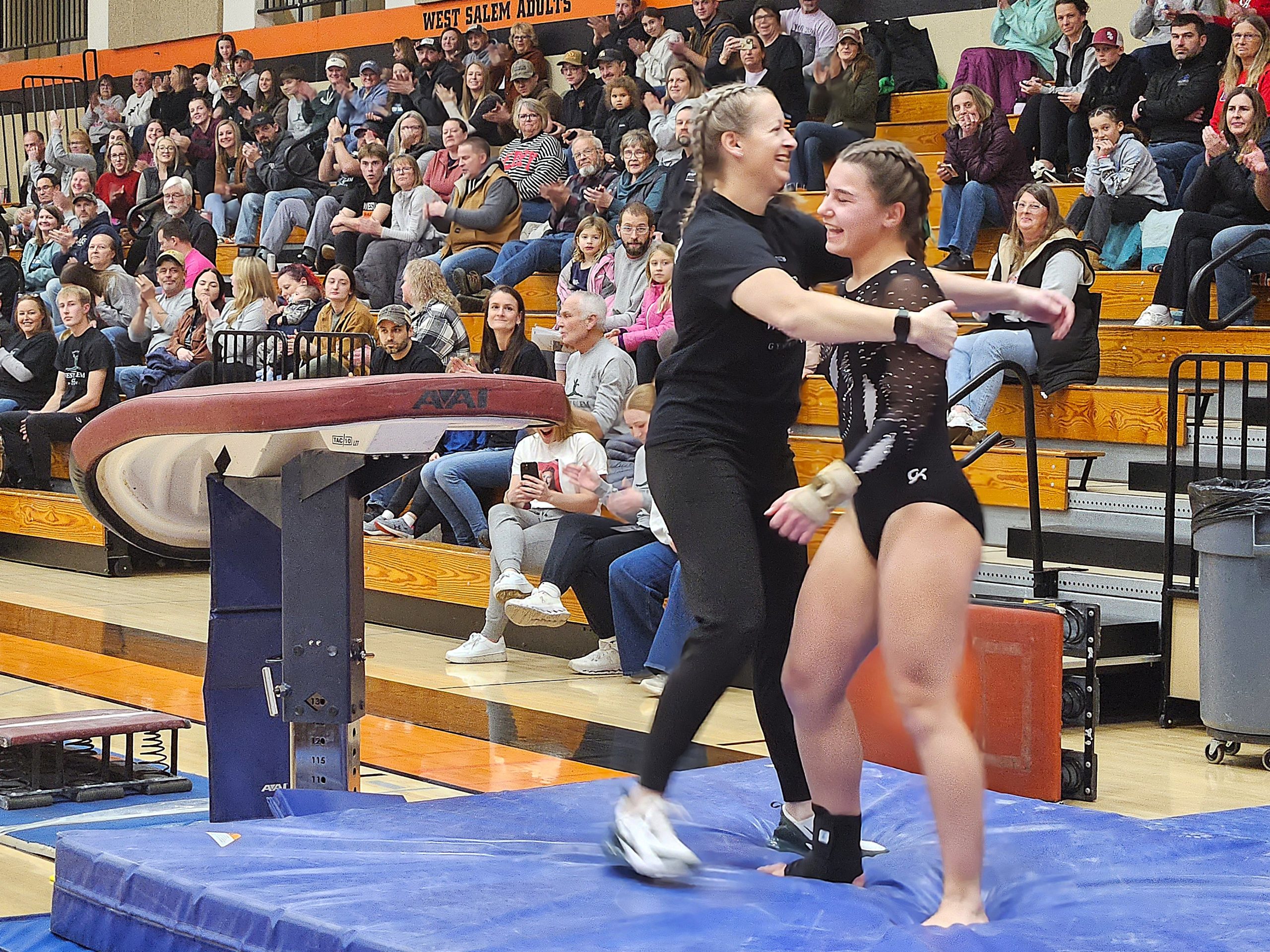 West Salem co-op senior Camdyn Lyga is congratulated by coach Carrie O'Hearn after her vault on Tuesday. -- TODD SOMMERFELDT PHOTO