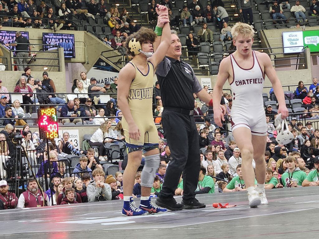 Aquinas sophomore Martez Sheard has his hand raised after winning the 126-pound championship at the Bi-State Classic. -- TODD SOMMERFELDT PHOTO