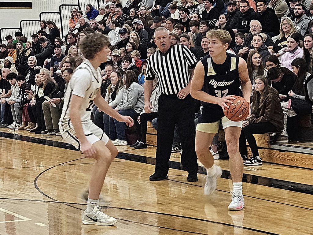 Aquinas senior Logan Becker holds the ball during the Blugolds' nonconference game at Onalaska Luther on Friday. -- TODD SOMMERFELDT PHOTO