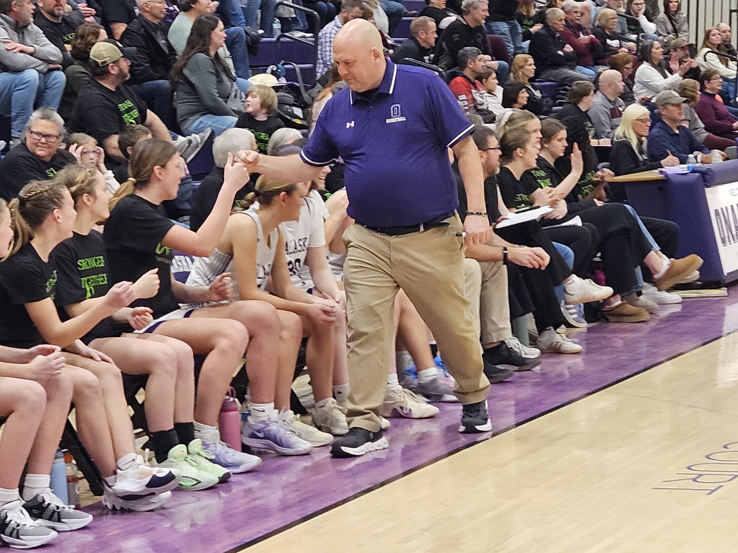 Onalaska girls basketball coach Toom Cowley celebrates with players on his bench near the end of a win over Holmen on Friday. -- TODD SOMMERFELDT PHOTO