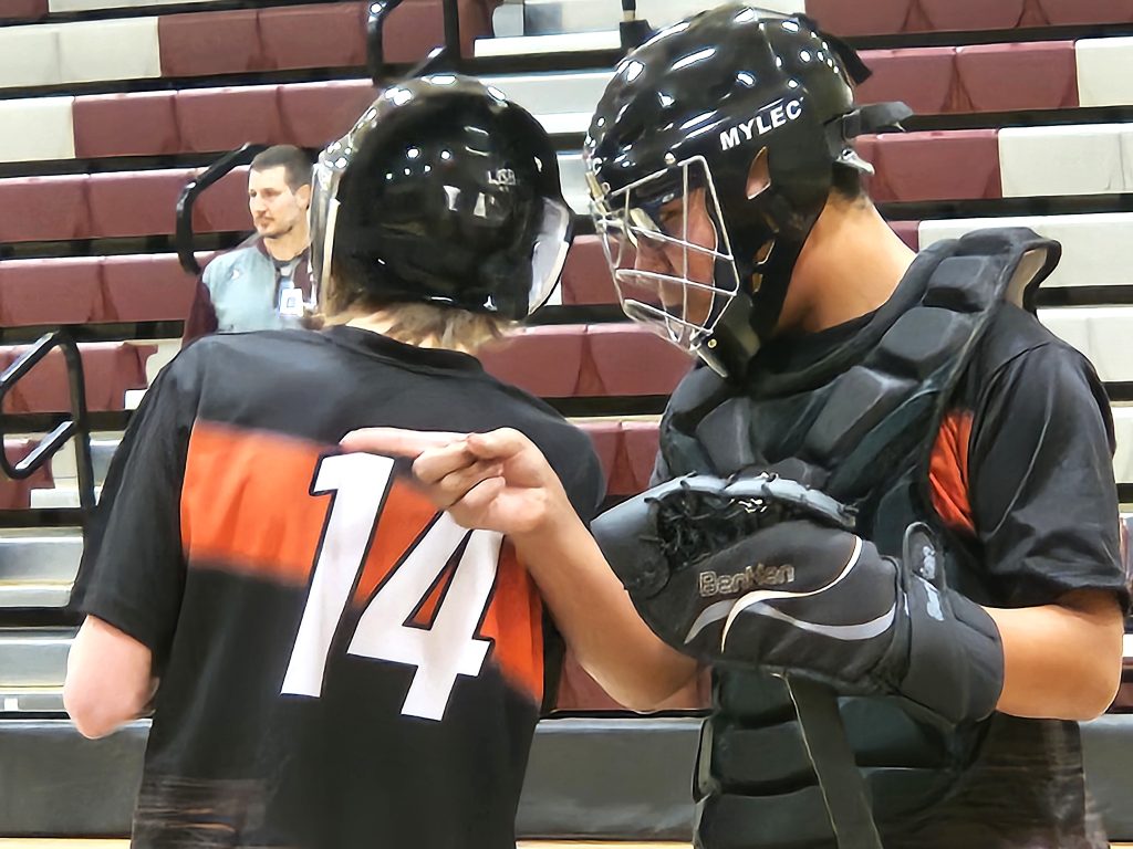 West Salem/Bangor's Levi Wulf talks to teammate Braylon Todd during an ASL floor hockey game against Holmen on Monday. -- TODD SOMMERFELDT PHOTO