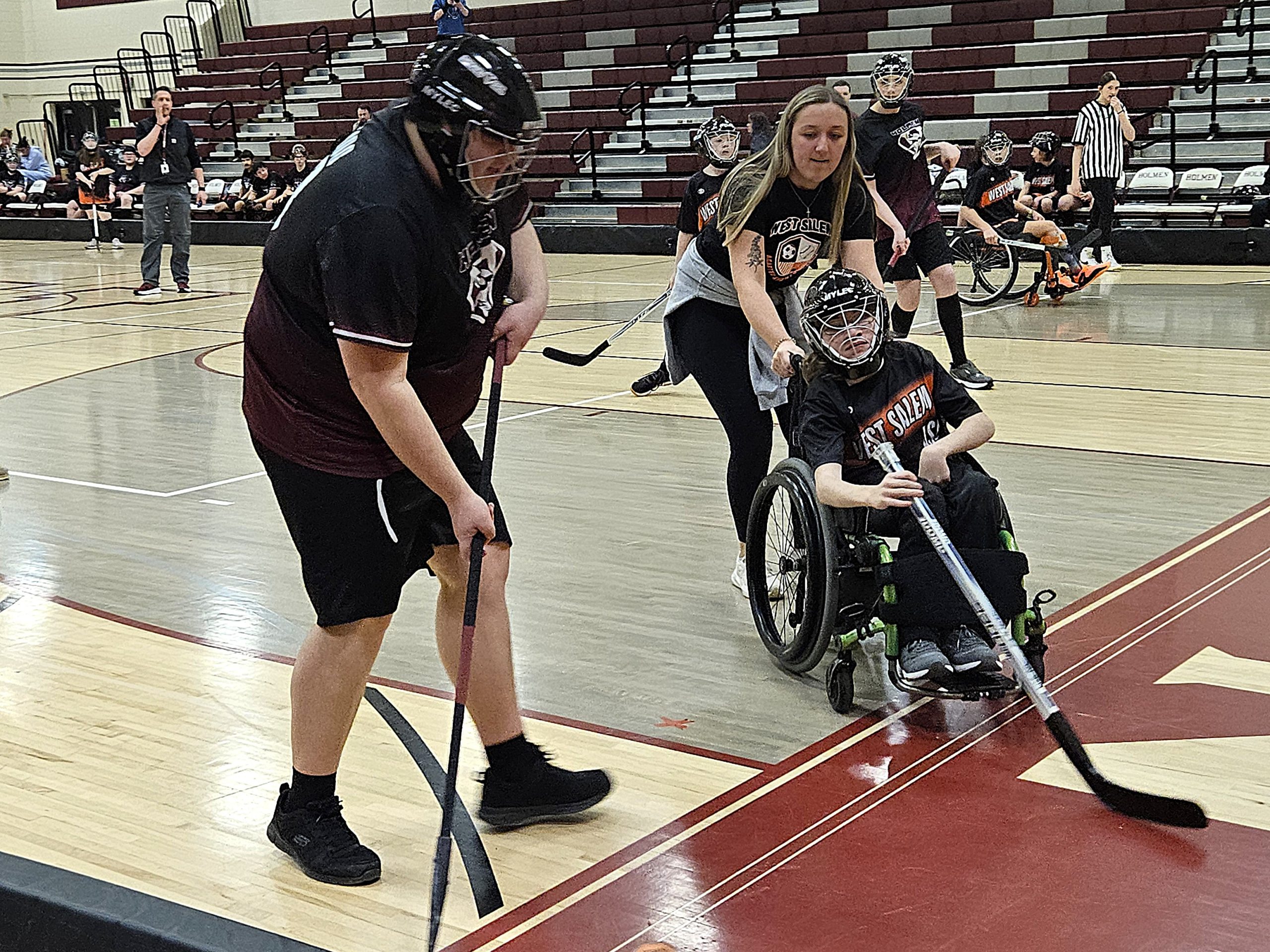 Holmen's Aiden Romskog and West Salem/Bangor's Hunter Stello converge on the puck during an ASL floor hockey game on Monday. -- TODD SOMMERFELDT PHOTO