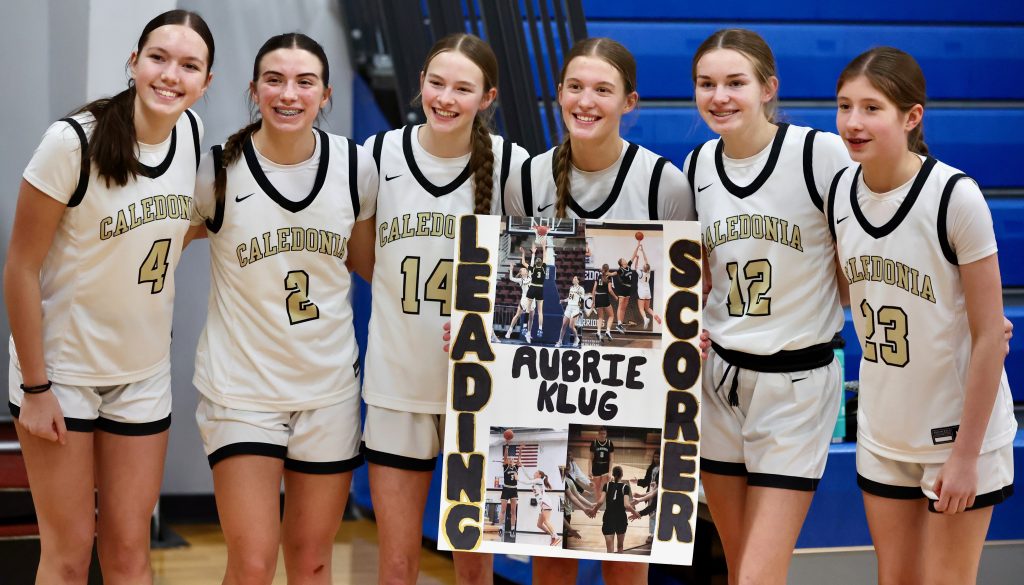 Caledonia senior Aubrie Klug poses with teammates after breaking her program's career scoring record on Friday. -- CRAIG JOHNSON PHOTO