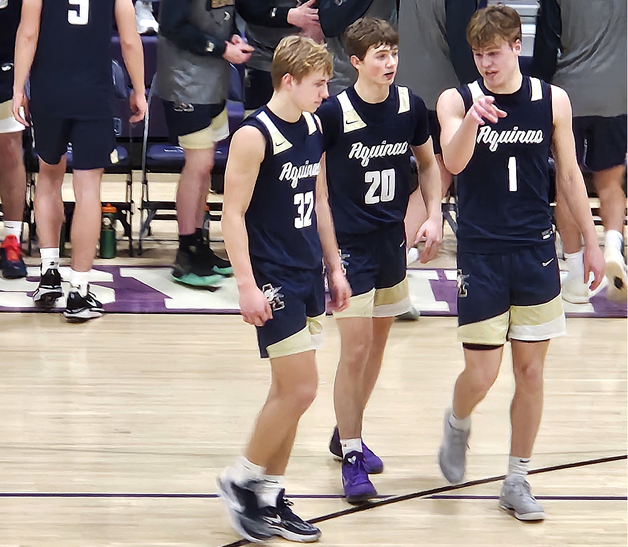 Logan Becker, Ryan Johnson and Calvin Bahr talk while entering Friday's game for Aquinas against Onalaska after a late timeout. -- TODD SOMMERFELDT PHOTO