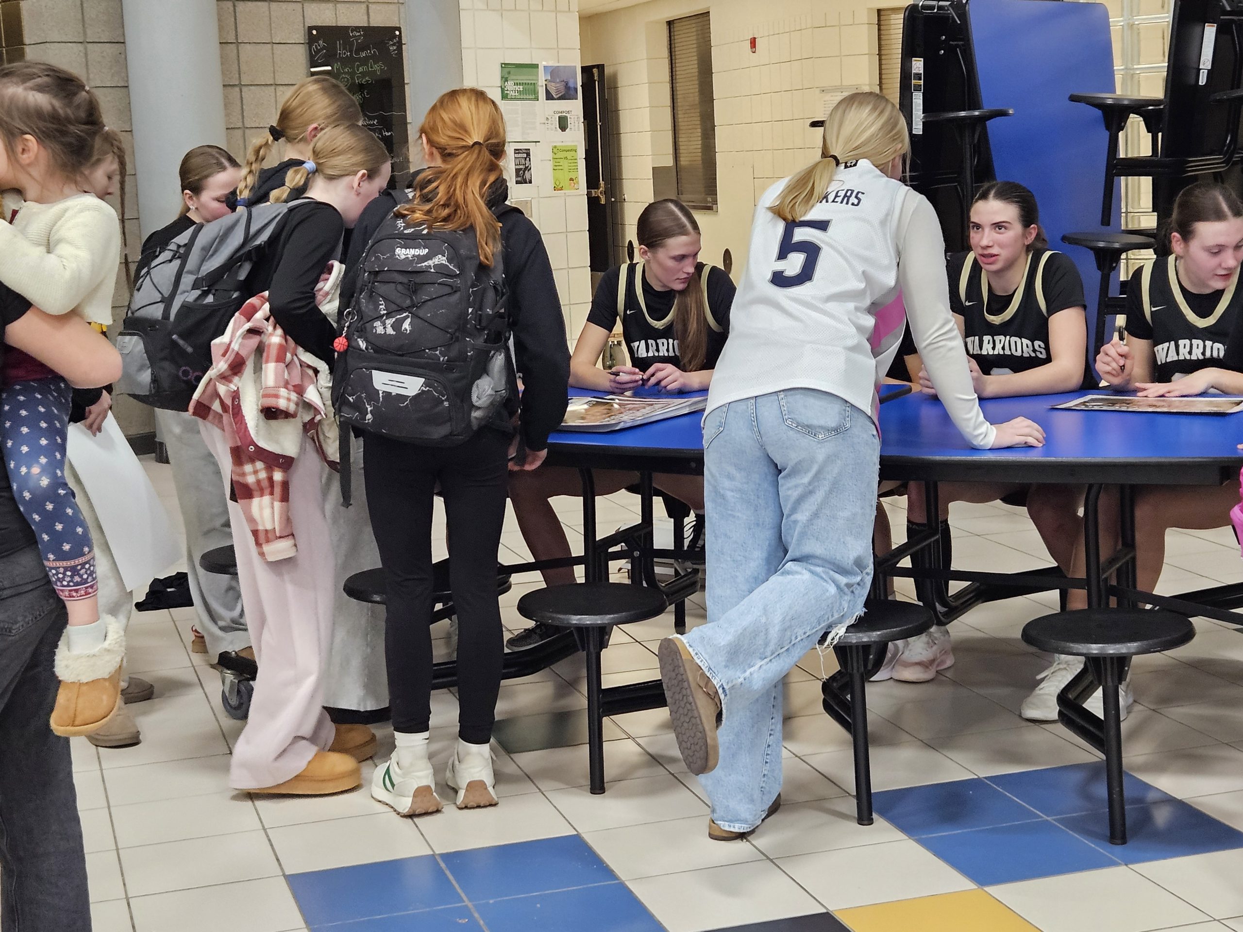 Players from the Caldonia girls basketball team sign autographs after beating Holmen on Monday. -- TODD SOMMERFELDT PHOTO