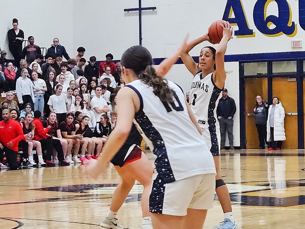 Aquinas senior Sammy Davis llooks for an open teammate during Thursday's 76-38 win over Central at the Reinhart Athletic Complex. -- TODD SOMMERFELDT PHOTO