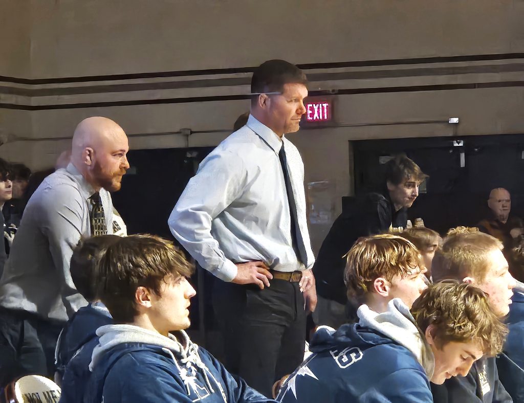 Aquinas wrestling coach Deke Stanek watches his Blugolds compete against Holmen in January. -- TODD SOMMERFELDT PHOTO