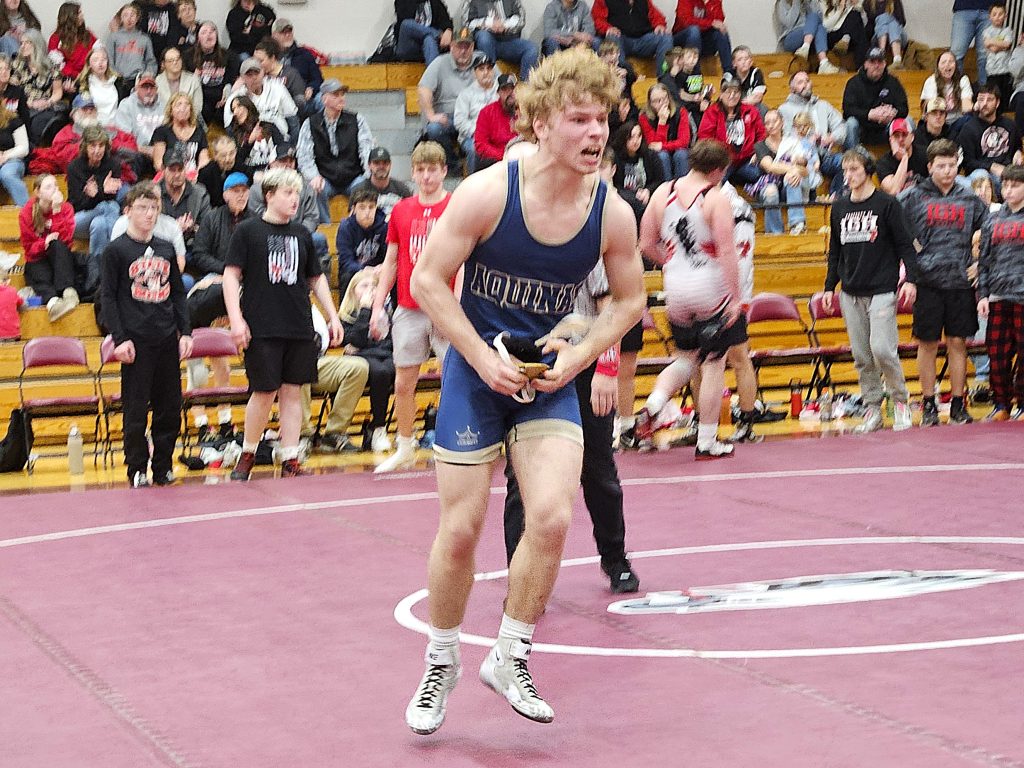 Aquinas junior Isaac Miller runs toward his teammates after a big victory at 215 poinds during a WIAA Division 2 sectional championship win over Iowa-Grant/Highland at Cashton on Saturday. -- TODD SOMMERFELDT PHOTO