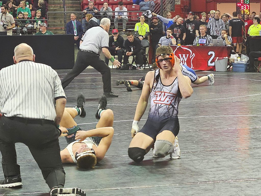 West Salem/Bangor senior Caden Anderson adjusts his headgear after winning a Division 2 first-round match at 190 pounds in the WIAA individual state tournament. -- TODD SOMMERFELDT PHOTO