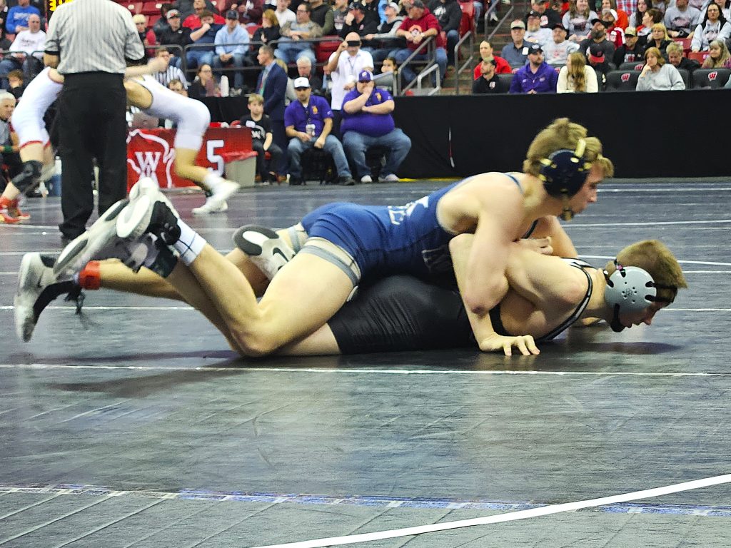 Aquinas senior Roger Flege wrestles a Division 3 144-pound quarterfinal mat at the Kohl Center in Madison. -- TODD SOMMERFELDT PHOTO
