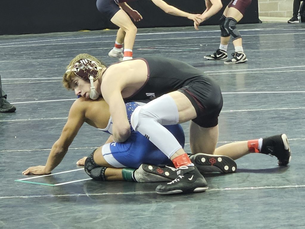 Holmen junior Brock Needham competes in a Division 1 126-pound quarterfinal at the Kohl Center in Madison. -- TODD SOMMERFELDT PHOTO