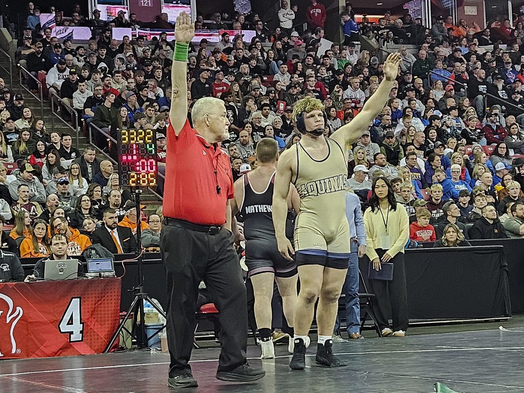 Aquinas senior Tyson Martin raises his hand as the victory after winning the Division 3 285-pound championship at the WIAA individual state tournament. -- TODD SOMMERFELDT PHOTO