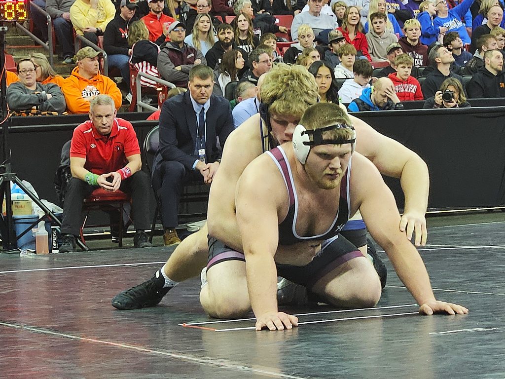 Aquinas senior Tyson Martin takes top position on Riverdale's Grant Mathews during their Division 3 285-pound championship match. -- TODD SOMMERFELDT PHOTO