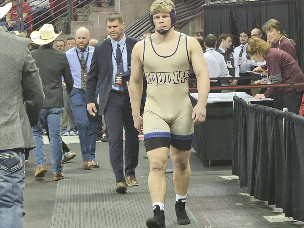 Aquinas senior Tyson Martin walks to the mat for his Division 3 285-poind championship match on Saturday. -- TODD SOMMERFELDT PHOTO