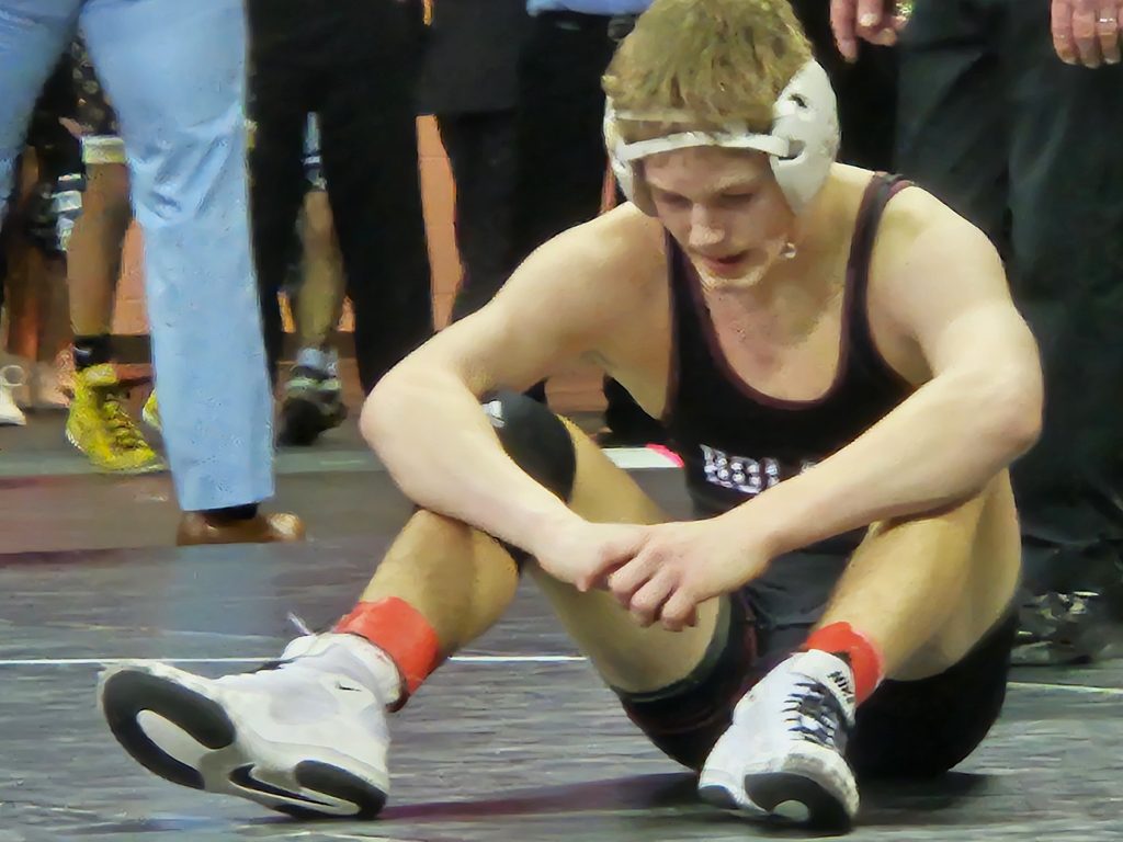 Holmen sophomore Rex Lancaster collects himself after a loss in the Division 1 120-pound championship match at the Kohl Center. -- TODD SOMMERFELDT PHOTO