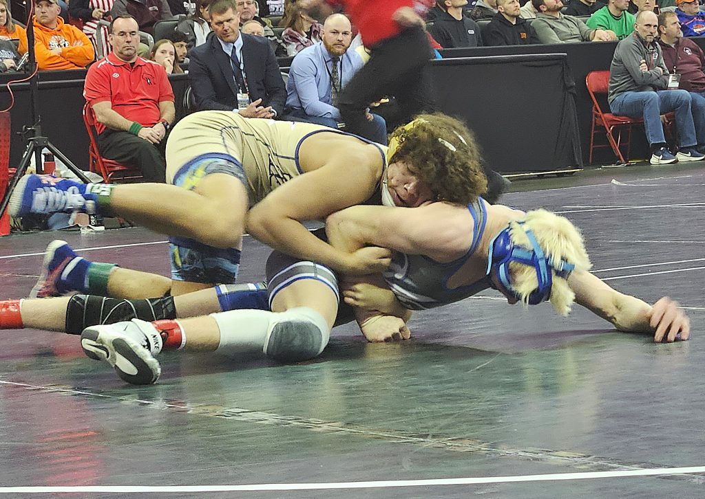 Aquinas sophomore Martez Sheard controls the action during his Division 3 126-pound championship match at the WIAA individual state wrestling tournament. -- TODD SOMMERFELDT PHOTO