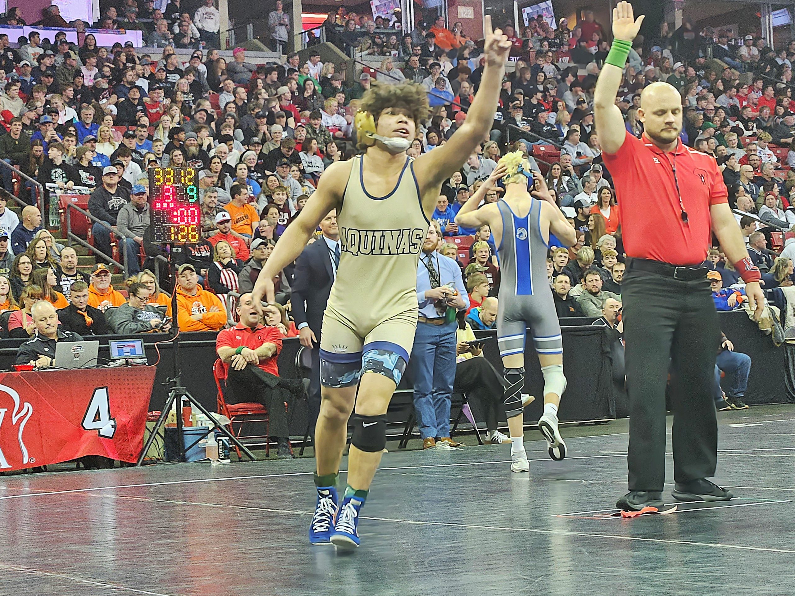 Aquinas sophomore Martez Sheard celebrates his Division 3 126-pound championship at the Kohl Center. -- TODD SOMMERFELDT PHOTO