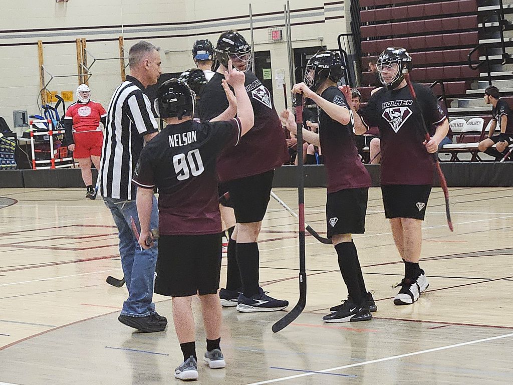 The Holmen ASL floor hockey team celebrates one of Carter Van Lin's three goals during a 4-0 victory over Logan on Tuesday. -- TODD SOMMERFELDT PHOTO