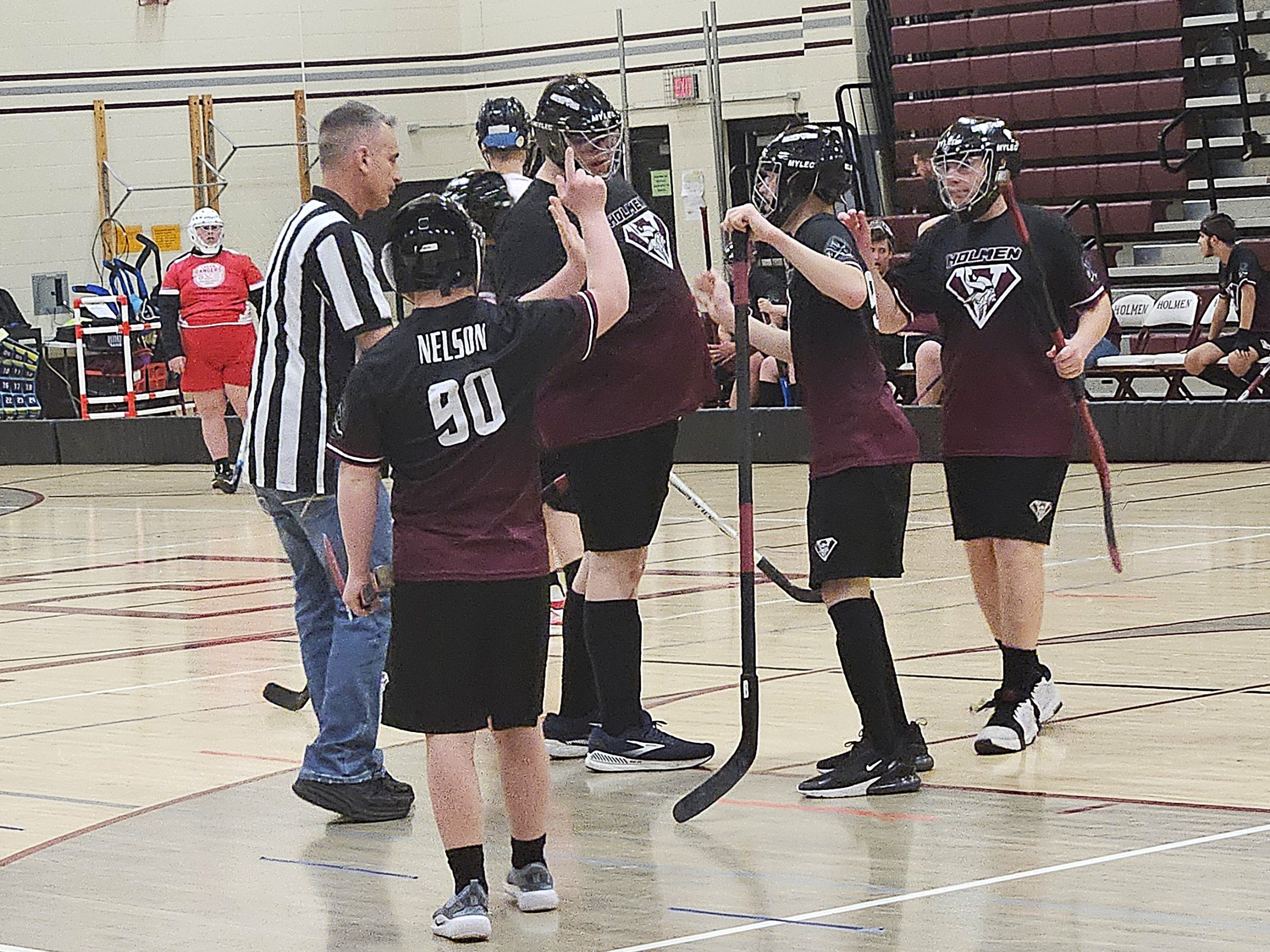 The Holmen ASL floor hockey team celebrates one of Carter Van Lin's three goals during a 4-0 victory over Logan on Tuesday. -- TODD SOMMERFELDT PHOTO